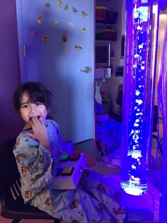 A child in a pajamas eating a piece of food
Description automatically generated